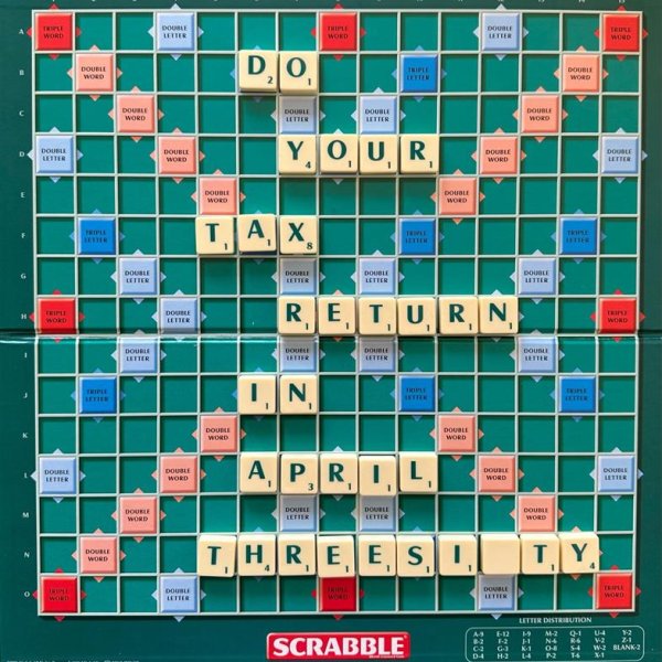 A Scrabble game board with tile pieces across the board spelling out 'Do your tax return in April Three Sixty'